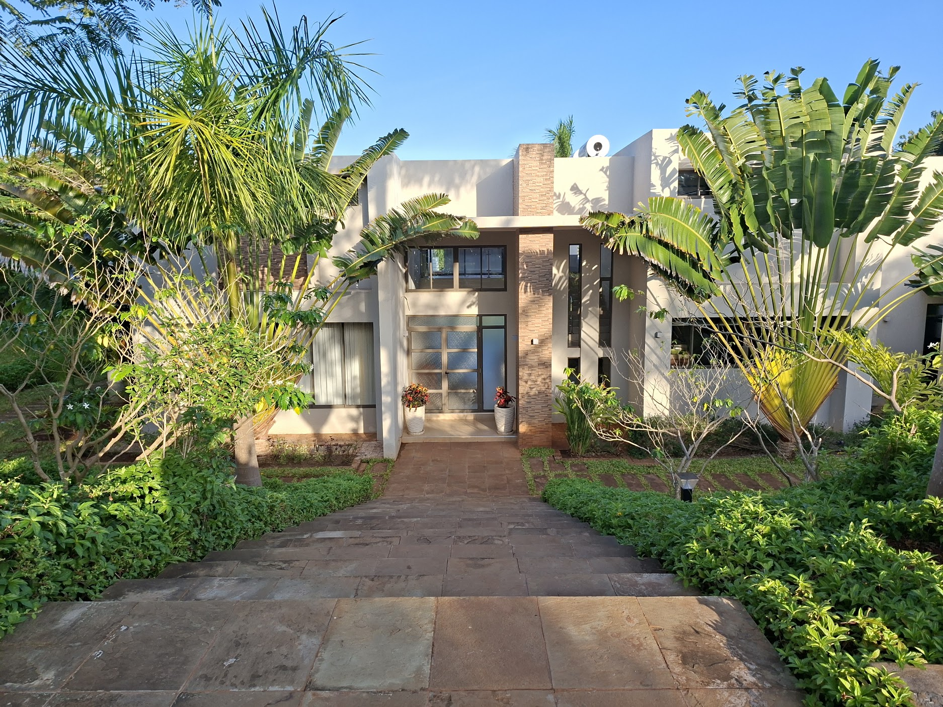 The Vipingo home exterior surrounded by tropical gardens